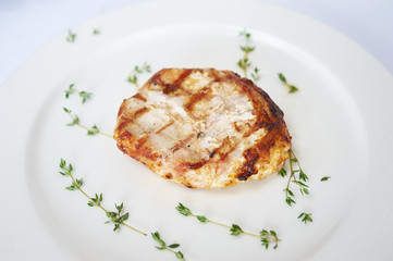 Grilled pork cue on white plate studio shot