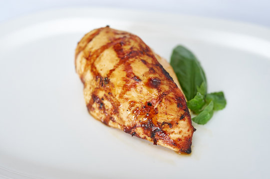 Chicken breast with mozzarella on white plate studio shot