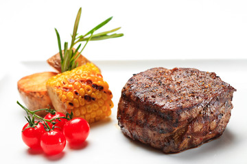 Pork steak  swith fresh vegetables isolated on white background. served beef steak with vegetables on a white background