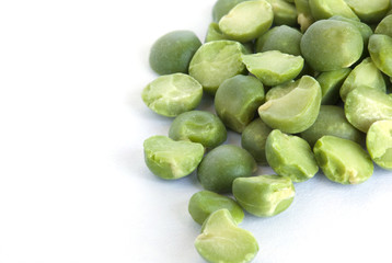 Dried green peas on a white surface