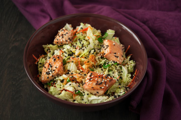 Fresh salad with napa cabbage, carrot, chicken, cilantro and sesame seeds