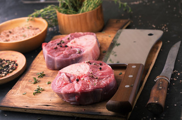Raw beef ossobuco on a wooden table