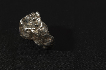 metallic meteorite with a black background