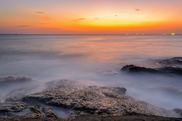 Long exposure seascape during blue hour sunset with rocks as foreground. Nature composition