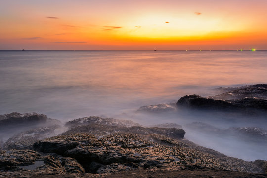 Long exposure seascape during blue hour sunset with rocks as foreground. Nature composition