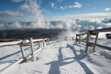 Snow covered winter trail. Blue sky and frozen view