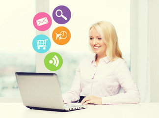 smiling businesswoman or student with laptop