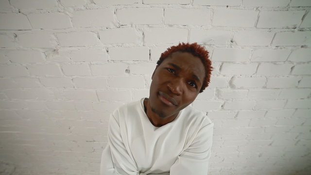 An insane black man in his forties wearing a straitjacket dance and have fun