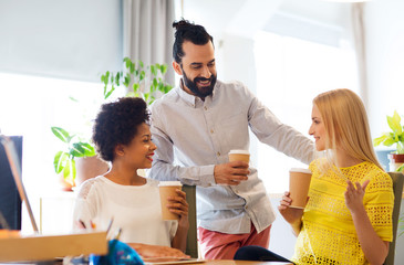 business team with coffee cups talking at office