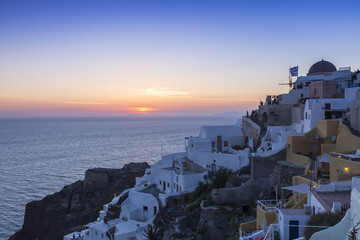 View of Oia traditional white houses of Oia at sunset in Santori