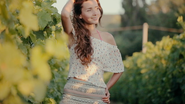 Attractive girl walking in the vineyards