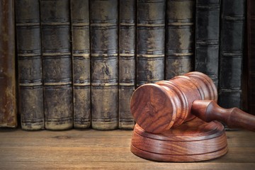 Wooden Judges Gavel And Old Law Books On Wooden Background
