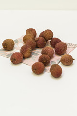 Lychees on a napkin, on the white background.