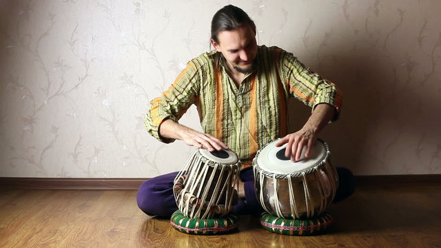 Man playing on Indian tabla drums 