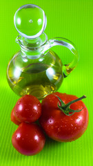 red tomato and olive oil isolated on yellow background
