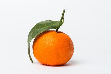 Fresh tangerine with green leaves isolated on white background