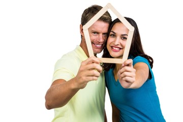 Portrait of happy couple holding frame