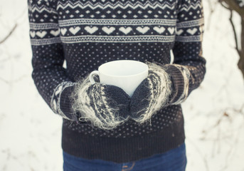 Girl holding a coffee mug.