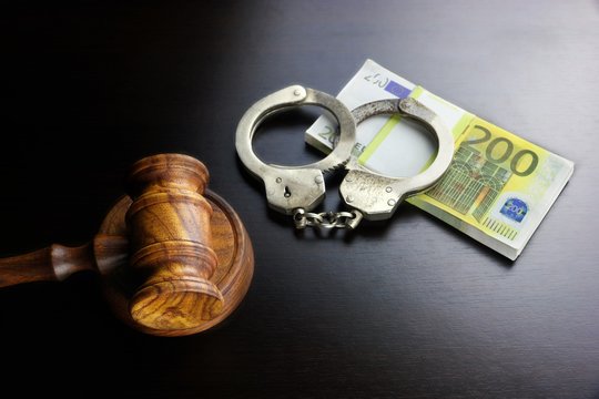 Judges Gavel, Handcuffs And Euro Cash  On The Black Table