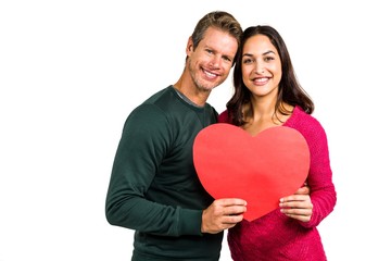 Portrait of smiling couple holding heart shape