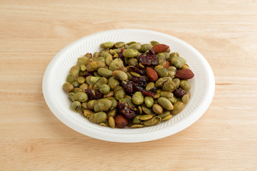 Edamame with nuts and dried fruit on white plate