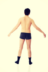 Fototapeta premium Young shirtless man with arms wide open.