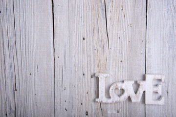 Word LOVE on old wooden background
