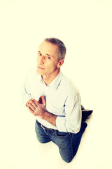 Man kneeling and praying to God
