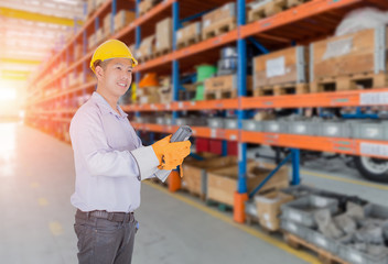Asia man scanning package with warehouse barcode scanner in modern storehouse