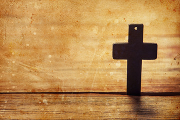 Old cross on a brown wood