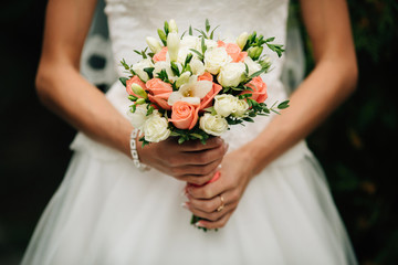 Very beautiful wedding bouquet in hands of the bride