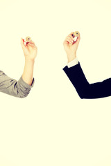 Two businesswomen holding pencils.
