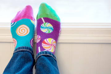Pair of odd socks on feet