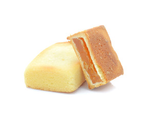 Fruit cake squares on white background.