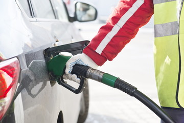 Fuel nozzle during refueling at a gas station.