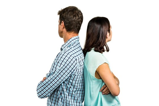 Couple ignoring each other while standing back to back