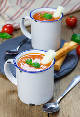 Homemade tomato basil soup in the mug, served with mozzarella cheese stick and croutons