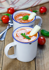 Homemade tomato basil soup in the mug, served with mozzarella cheese stick and croutons