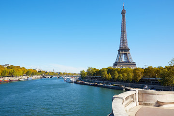 Eiffel tower and empty white balcony on Seine river in autumn