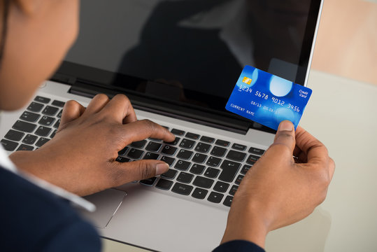 Businesswoman Using Debit Card While Shopping Online