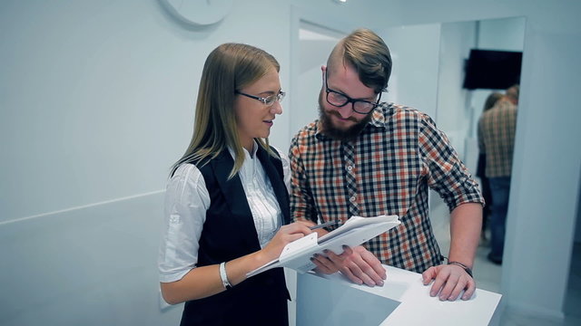Receptionist showing the customer list of services