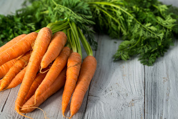 Fresh carrots bunch on wooden background