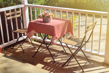 Table and chair in coffee shop with shadow and sunlight