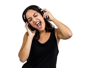 Beautiful woman enjoying music through headphones
