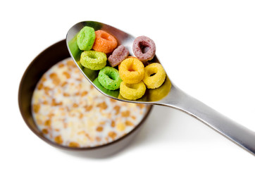 Close up of a spoon above a bowl with cereals and milk, isolated - Powered by Adobe