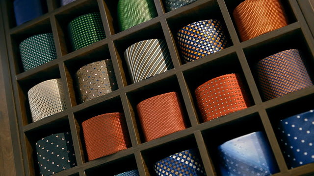 A lot of ties are lying folded on the shelves
