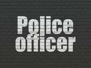 Law concept: Police Officer on wall background