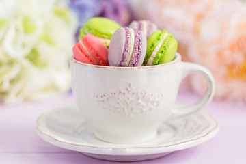 Colorful tiny macaroons in the cup