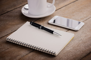 cup of coffee, notebook, pen and smart phone