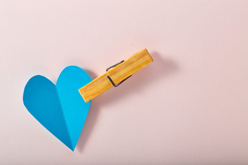 Blue paper heart on pink paper